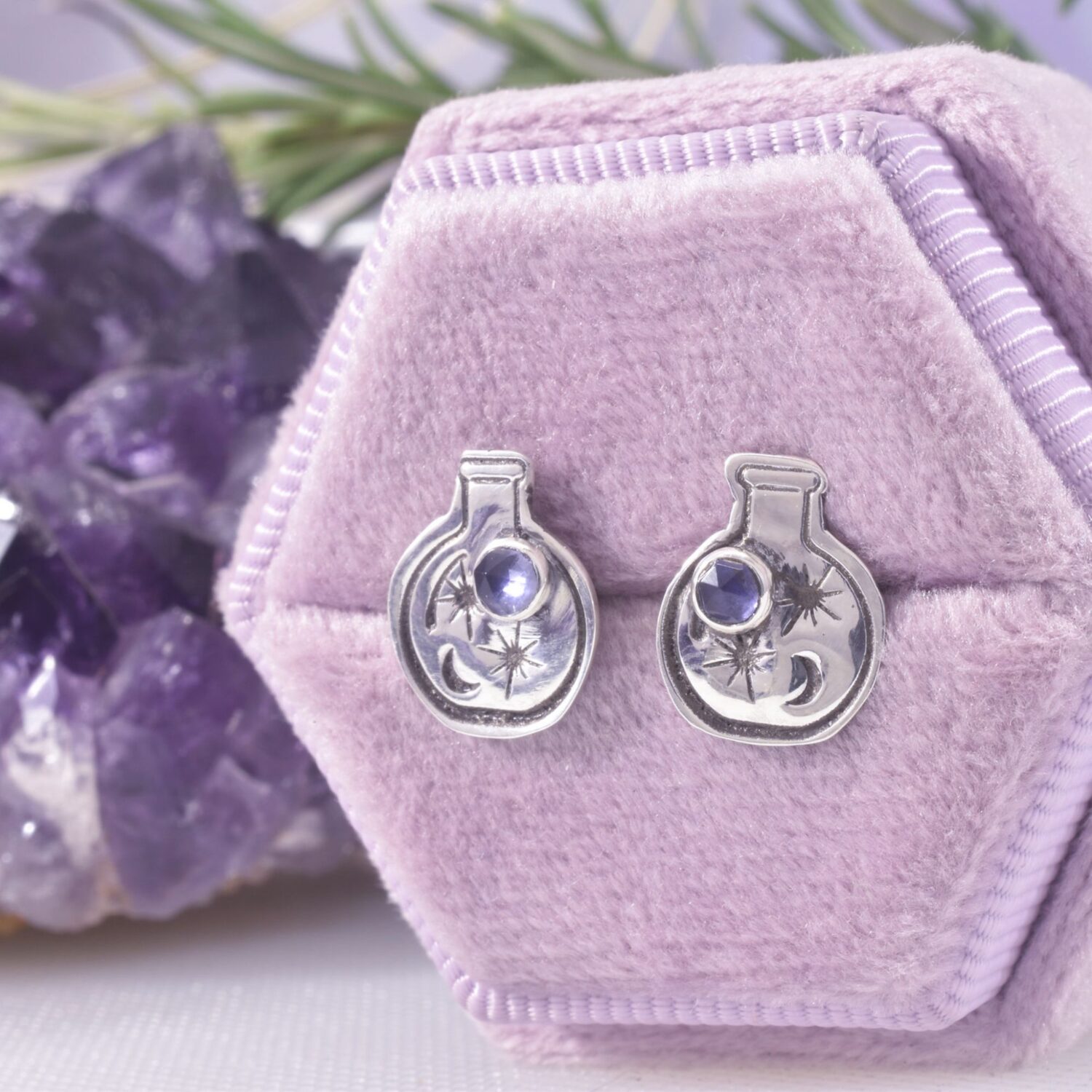 Sterling silver round bottom 2d potion flasks, filled with 2 stars and a moon, along with a 3mm faceted blue-purple Iolite crystal set in the bottle.