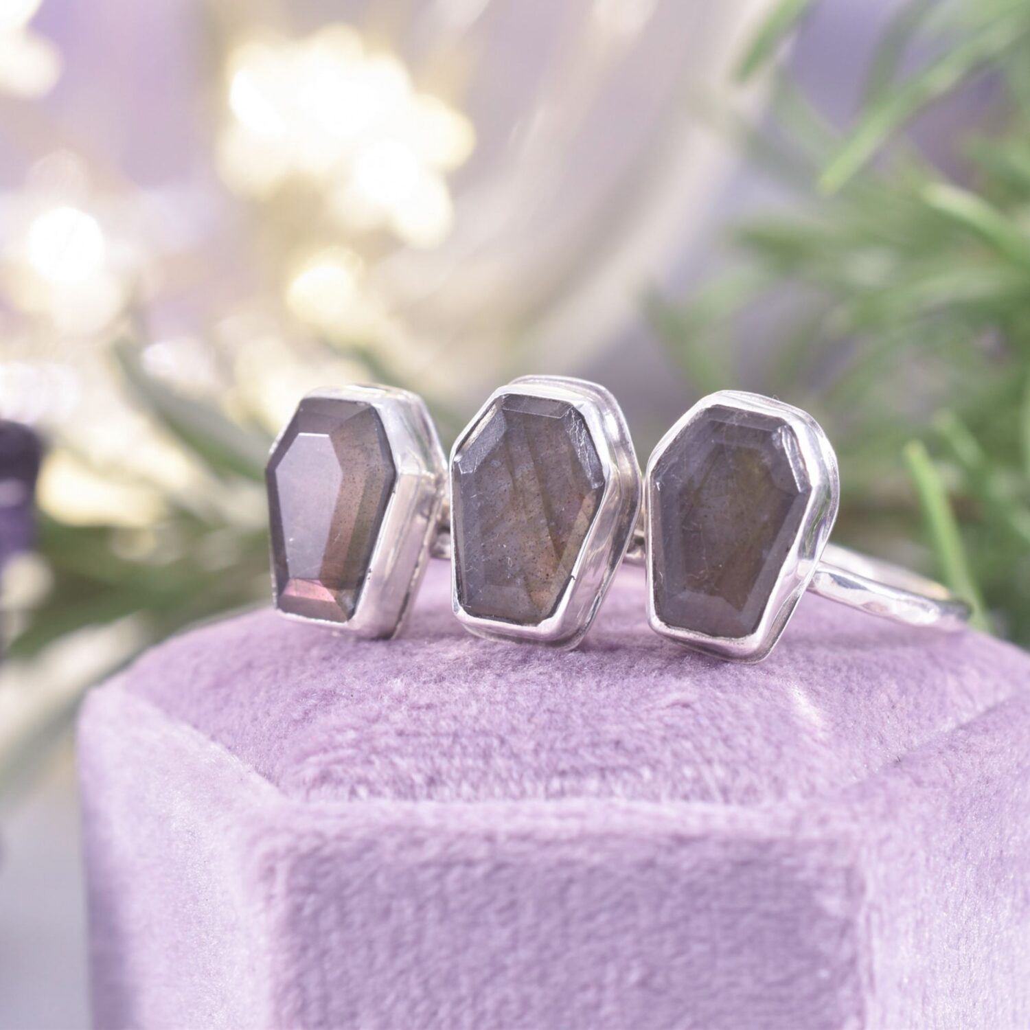 A trio of coffin shaped labradorite rings with purple flash