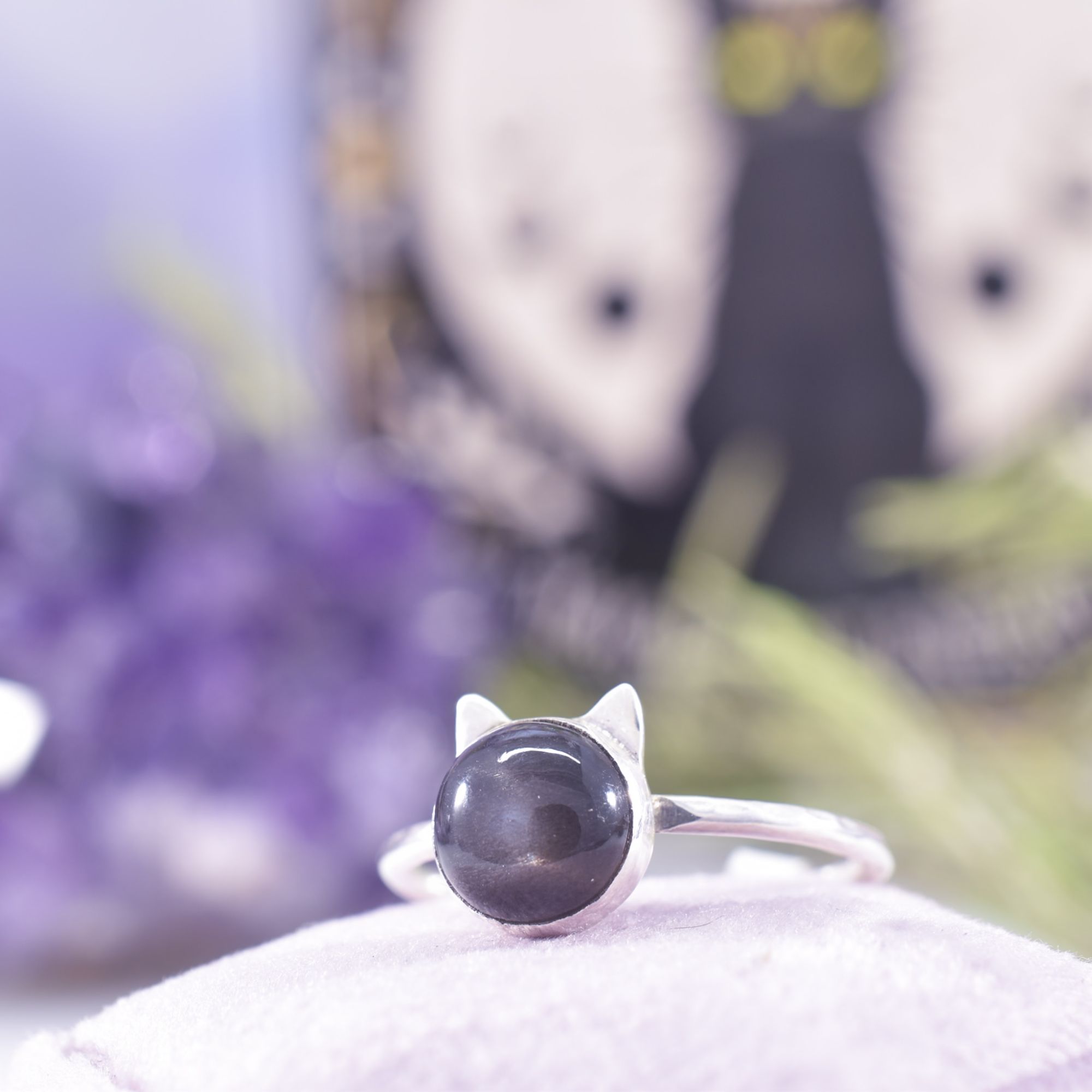 A round black moonstone, set in silver with a pair of tiny silver cat ears, set on a hammered silver ring band. Perfect for cat lovers!