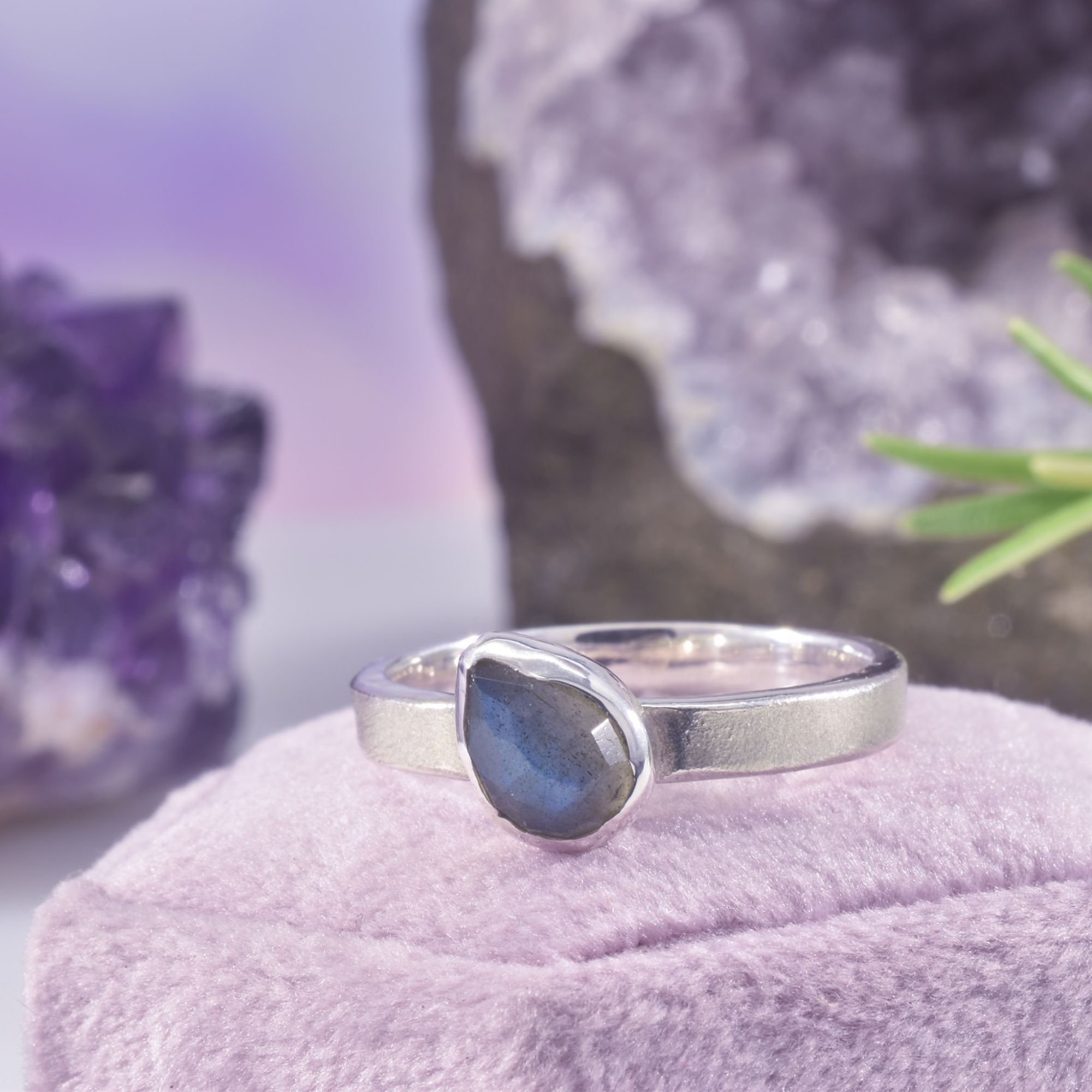 The midnight magic ring. A rose cut teardrop of labradorite in a high shine setting at a quirky angle, upon a medium band of brushed satin silver. A perfect contrast between high shine sparkle and brushed silver.